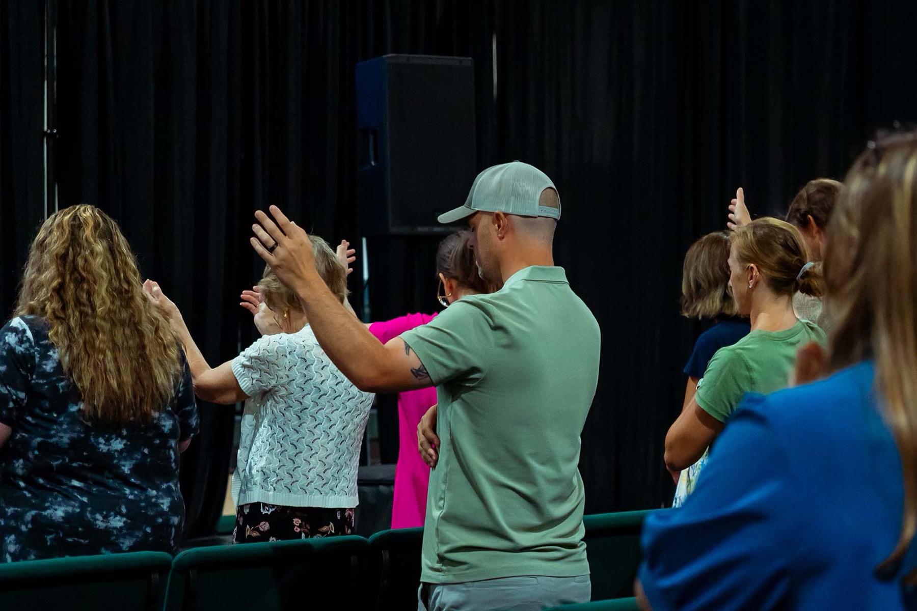 Hands raised during worship at River City Church