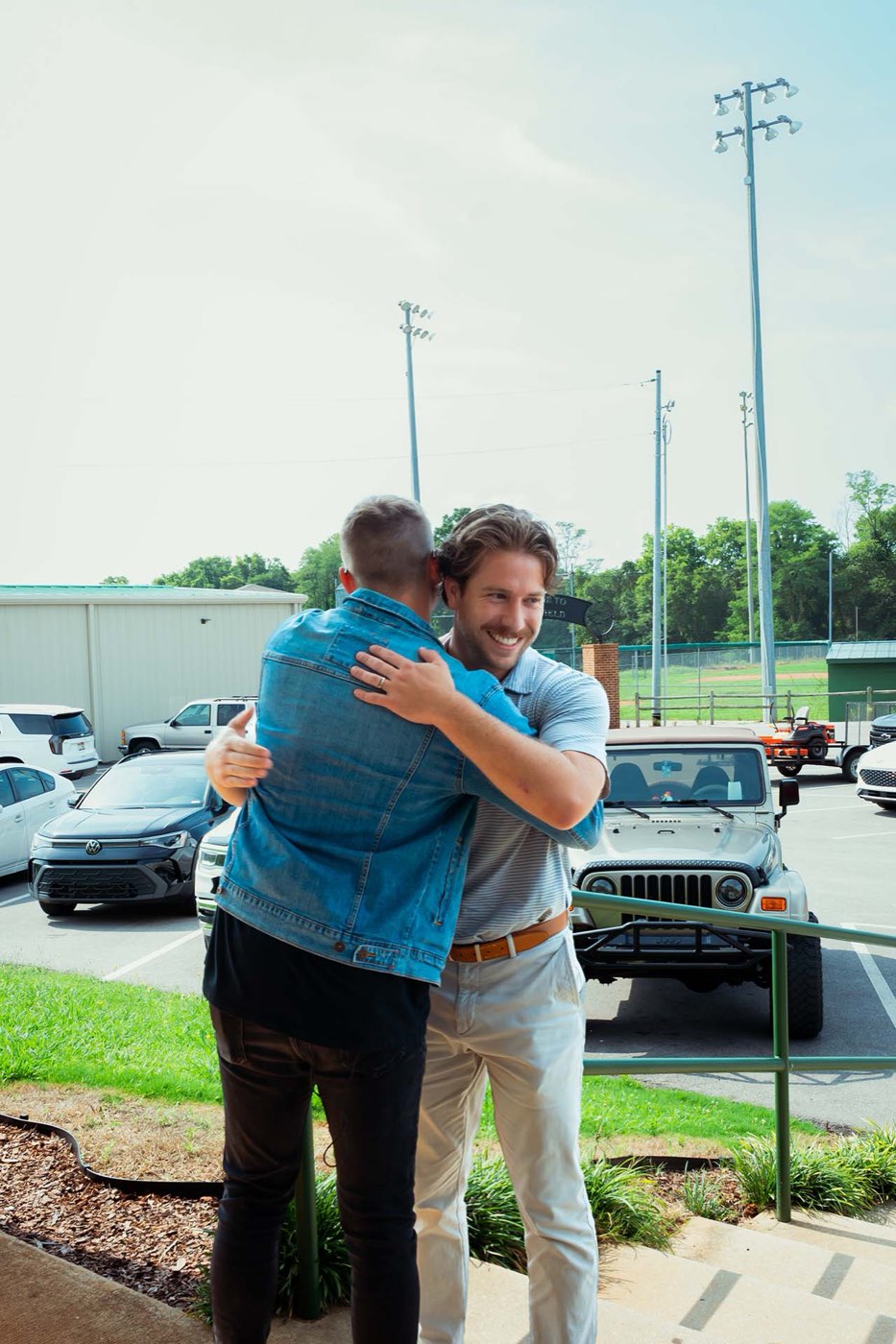 Two men greeting each other in the car park